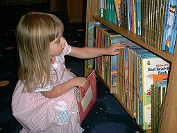 [Anna selects a book]
